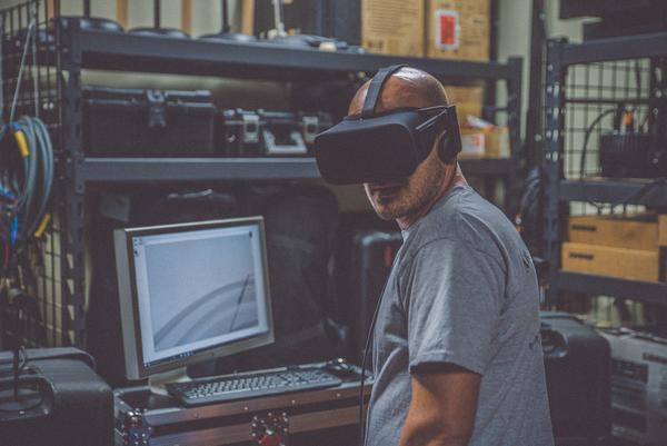 developer uses a VR headset to test out a virtual reality app written with C# coding language