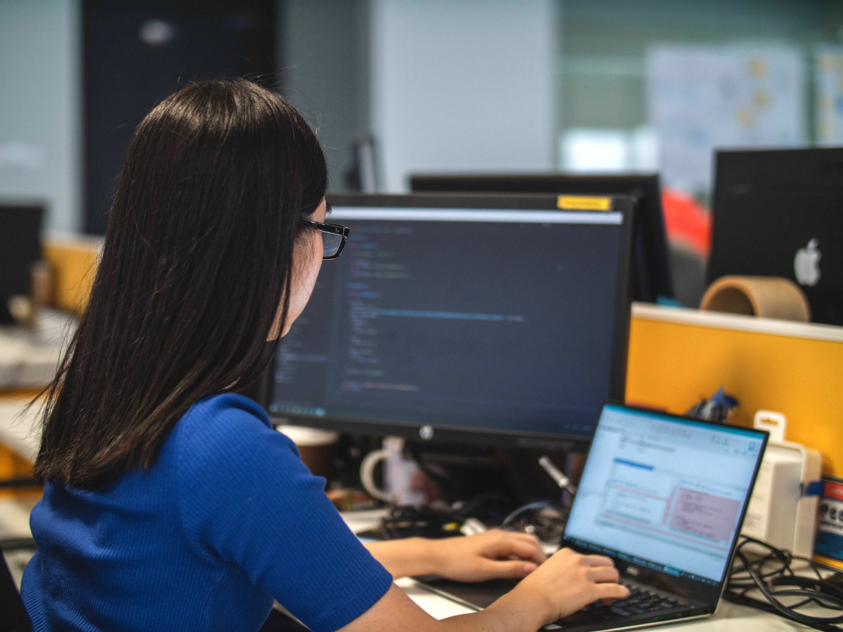Nonprofit developer using a laptop in an office Nonprofit developer using a laptop in an office
