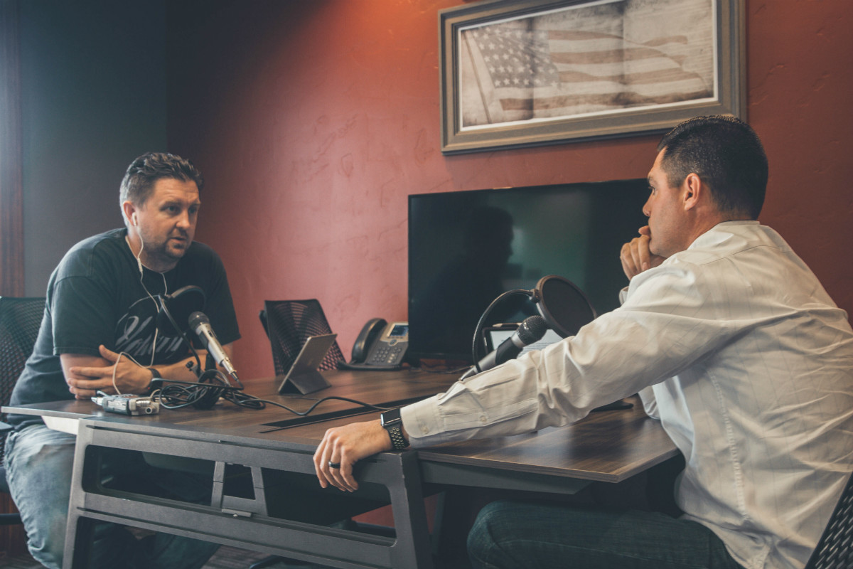 Two men with radio microphones illustrating the idea of Chicago tech podcasts Two men with radio microphones illustrating the idea of Chicago tech podcasts