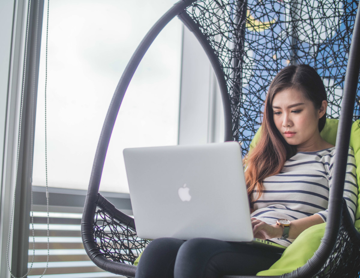 Woman with a laptop consider options for her first job after coding bootcamp Woman with a laptop consider options for her first job after coding bootcamp