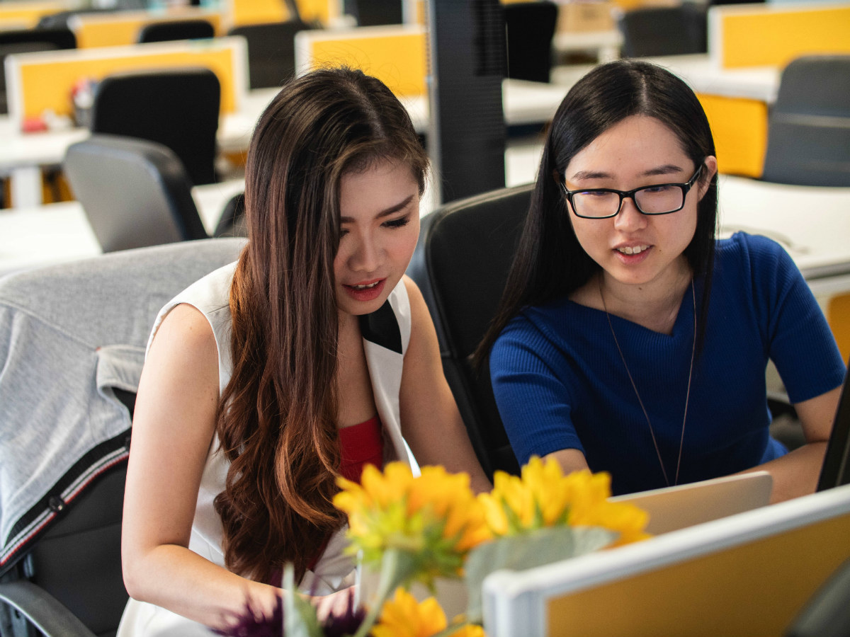 Two Women collaborating on laptops: on the best path to best path to a web developer job Two Women collaborating on laptops: on the best path to best path to a web developer job