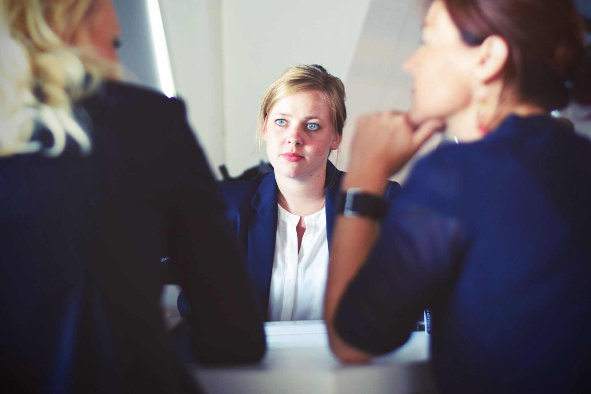 Woman being interviewed by two women
